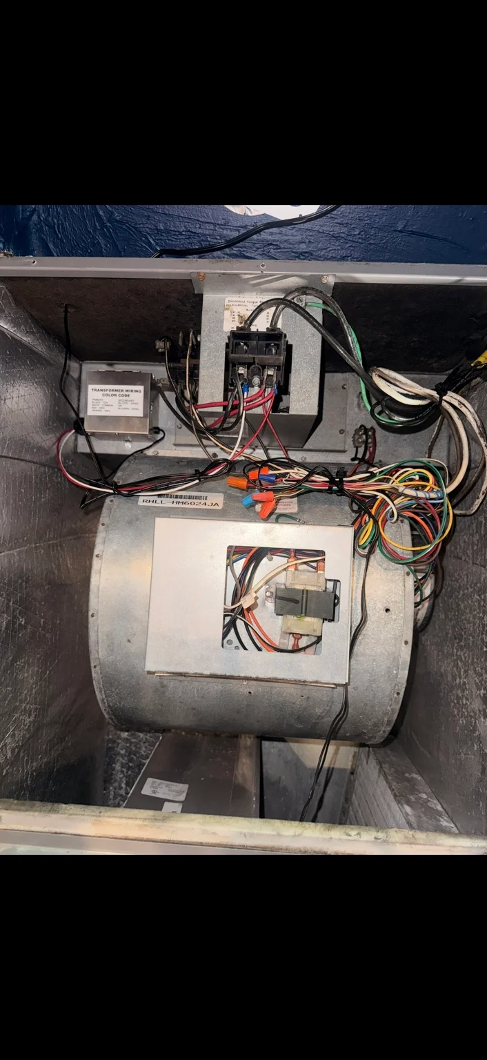 Open air handler showing the blower, wiring and electrical controls