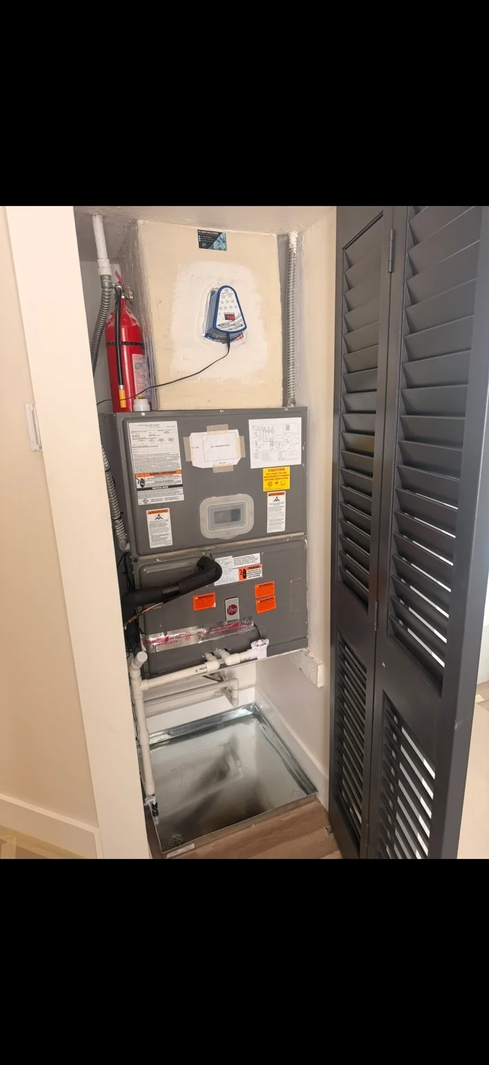 Air handler with an external control unit and auxiliary drain pan