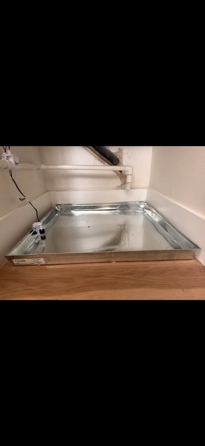 Auxiliary drain pan with a float switch below an air handler
