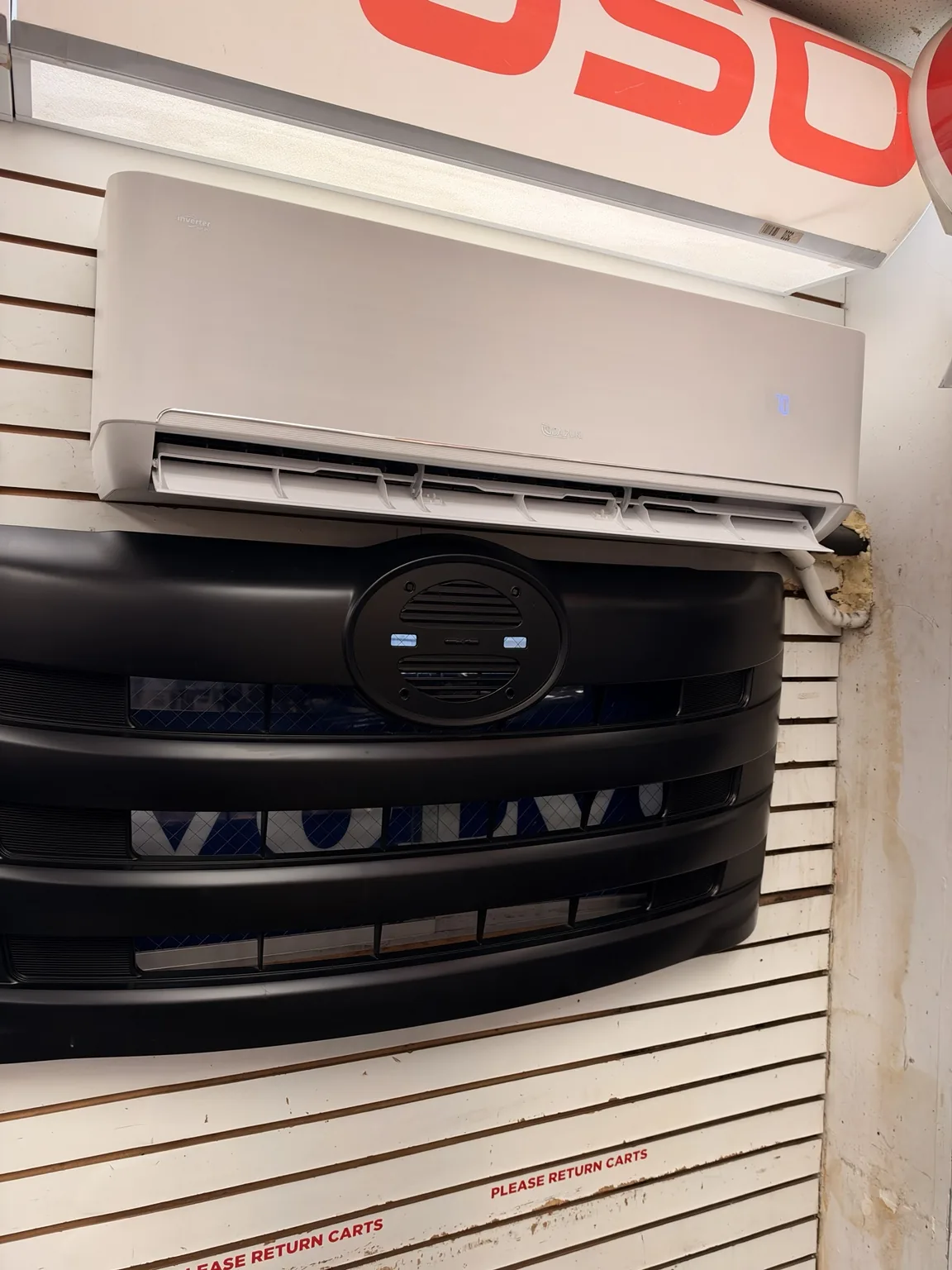 Reassembled wall-mounted mini-split with its display illuminated
