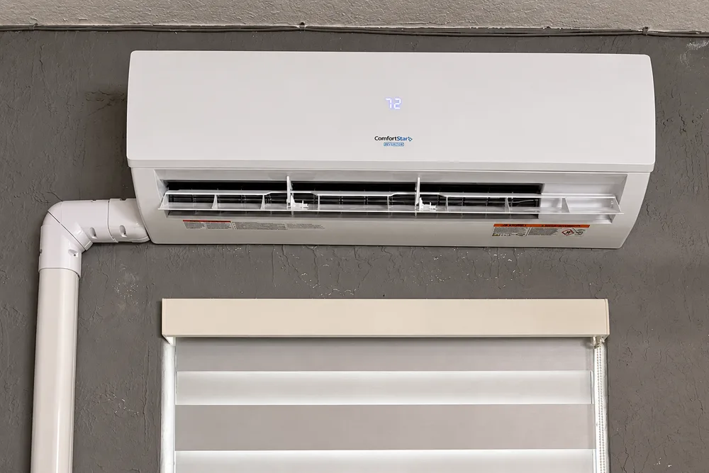 Wall-mounted ComfortStar indoor mini-split above a window