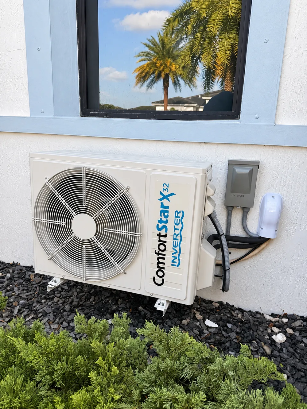 ComfortStar outdoor mini-split with refrigerant lines and electrical disconnect