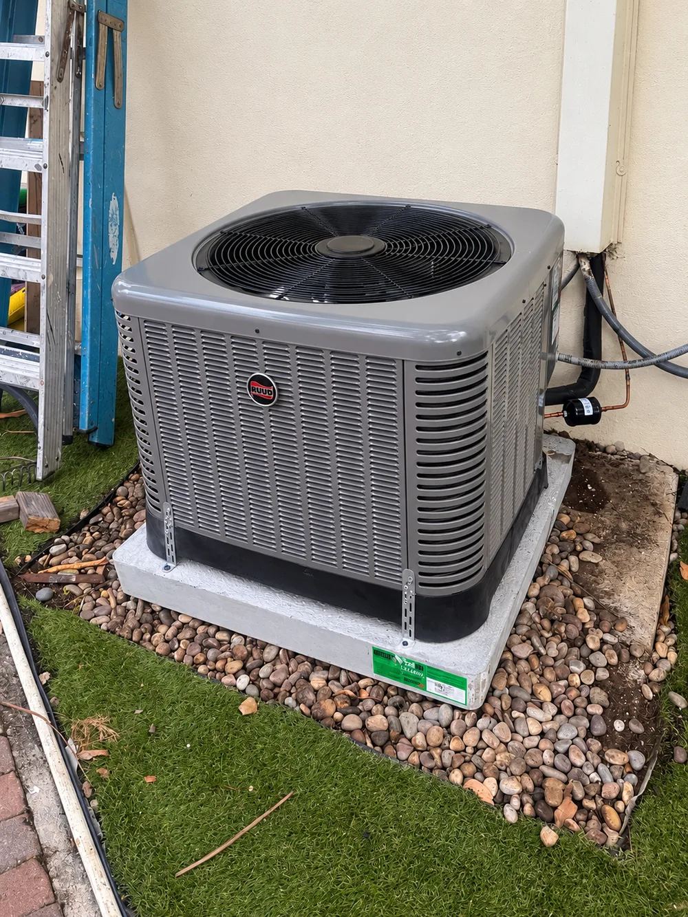 RUUD outdoor condenser with piping and electrical conduit